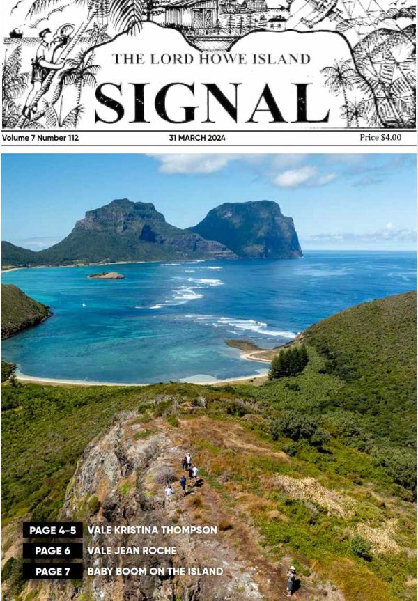 The front page of the Lord Howe island Signal with an idyllic coastal scene showcasing a broad view of a blue lagoon with coral patches, surrounded by a sandy shore, lush green hills, and two towering, rugged mountain peaks under a clear blue sky.