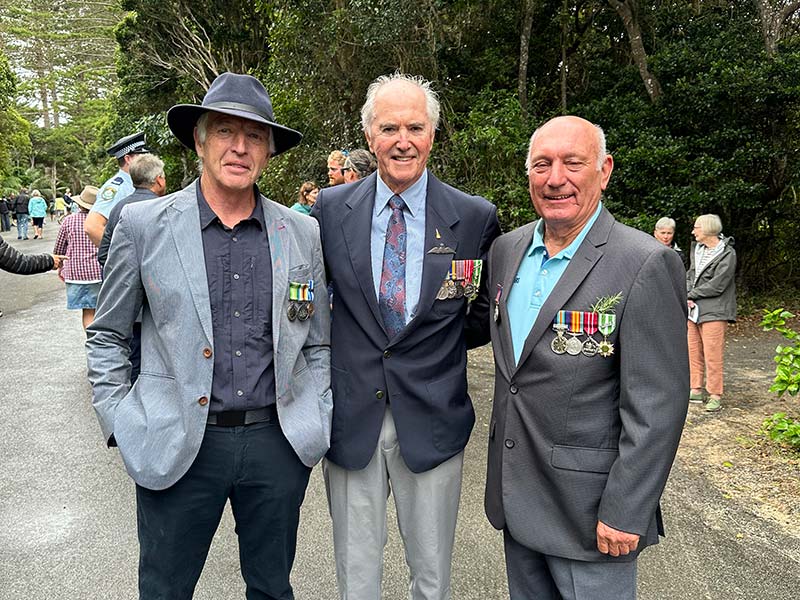 Three men attending the commemoration ceremony held at the Lord Howe Island Cenotaph on Anzac Day.