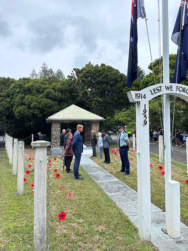 People line up at the Lord Howe Island Cenotaph on Anzac Day for the commemoration ceremony.