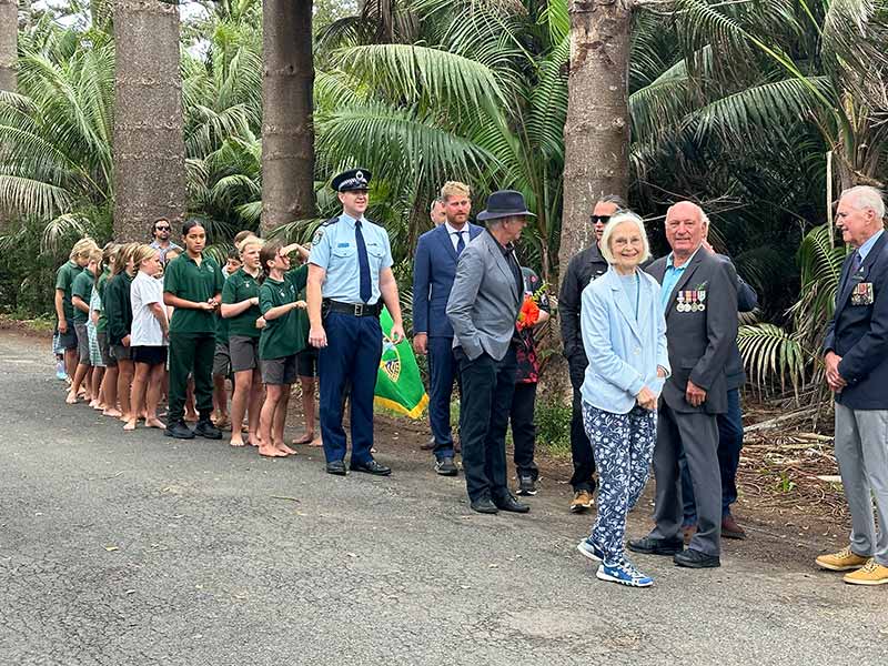 A group of school children gathers on Anzac Day for the commemoration ceremony held at the Lord Howe Island Cenotaph.