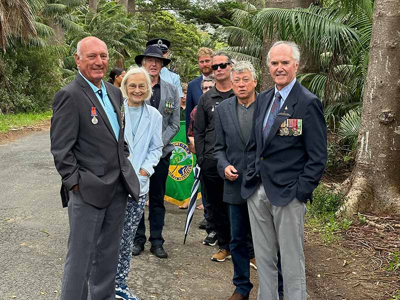 A group gathers on Anzac Day for the commemoration ceremony held at the Lord Howe Island Cenotaph.