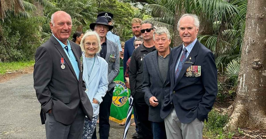 A group gathers on Anzac Day for the commemoration ceremony held at the Lord Howe Island Cenotaph.