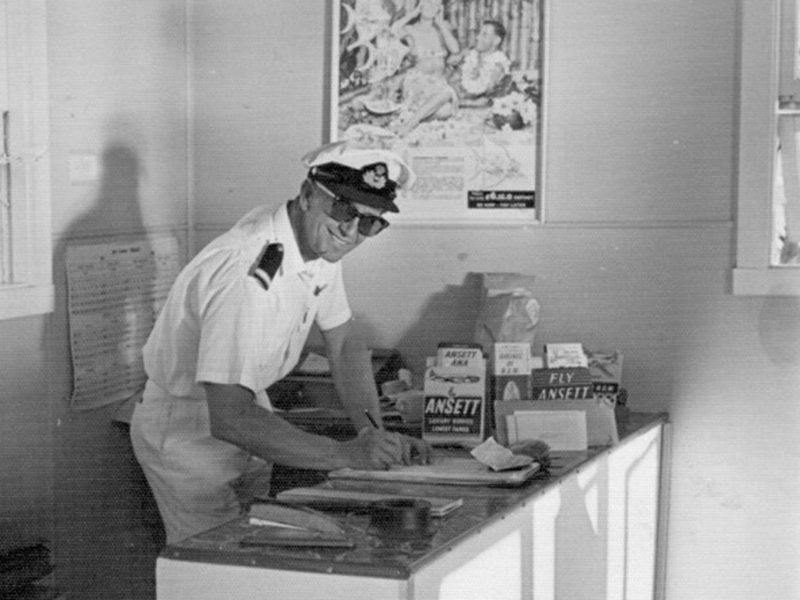 David at the counter of the new Lord Howe flying boat terminal - backed by holiday advertising - and looking a bit like a poster ad himself!