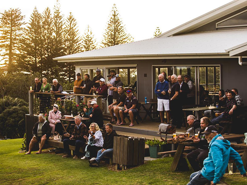 A photo of the spectators outside the Lord Howe Island Golf Club watching the Golf Open.