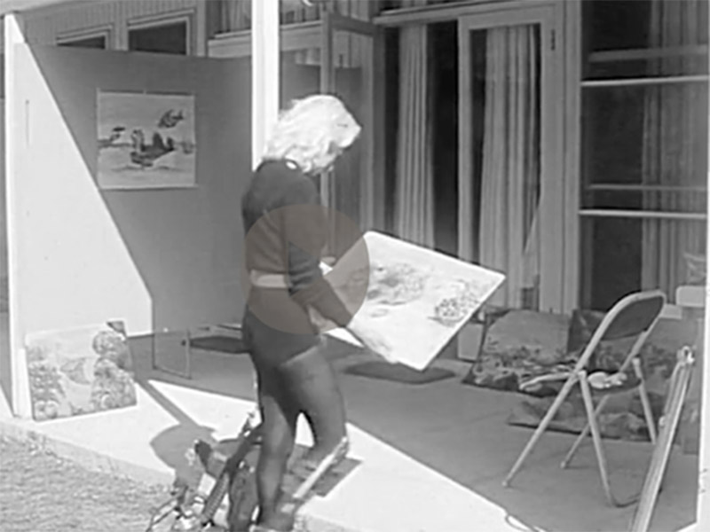 In this image Julie Booth is looking at one of her underwater drawings.