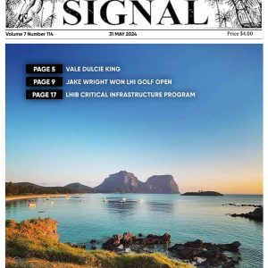 This is the front cover of the Signal Issue 114, May 2024 It is an image of Lagoon Beach with beautiful green foreshore overlooking the beach and boats. In the distance is Mt Lidgbird and Mt Gower as the sun sets and not a cloud in the sky.