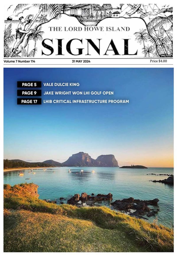 This is the front cover of the Signal Issue 114, May 2024 It is an image of Lagoon Beach with beautiful green foreshore overlooking the beach and boats. In the distance is Mt Lidgbird and Mt Gower as the sun sets and not a cloud in the sky.