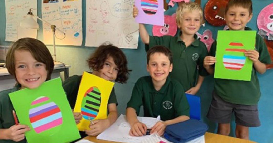 Lord Howe Island Central School students proudly showing their work.