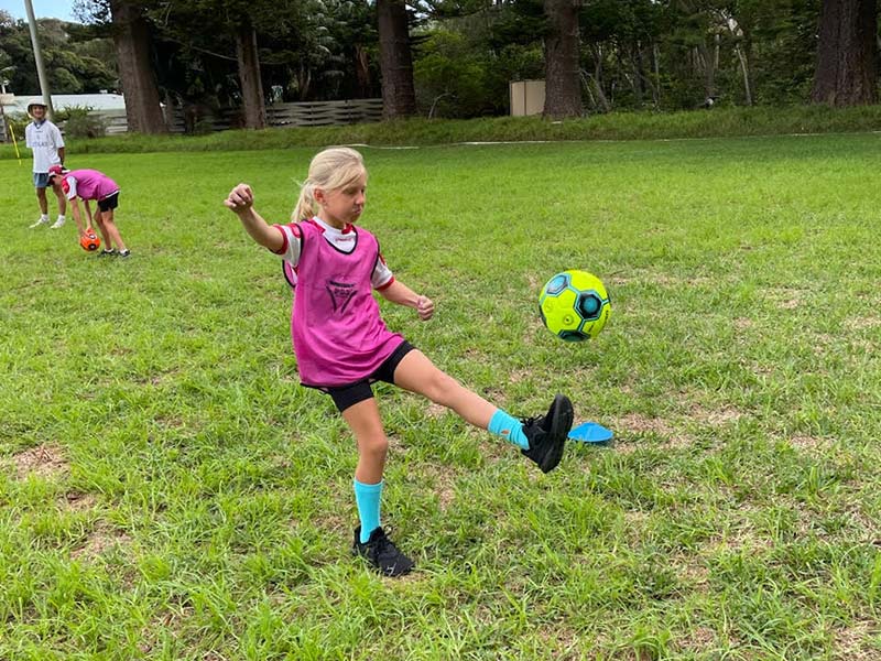 A soccer player takes a kick at the soccer ball at the recent Lord Howe Island soccer camp.