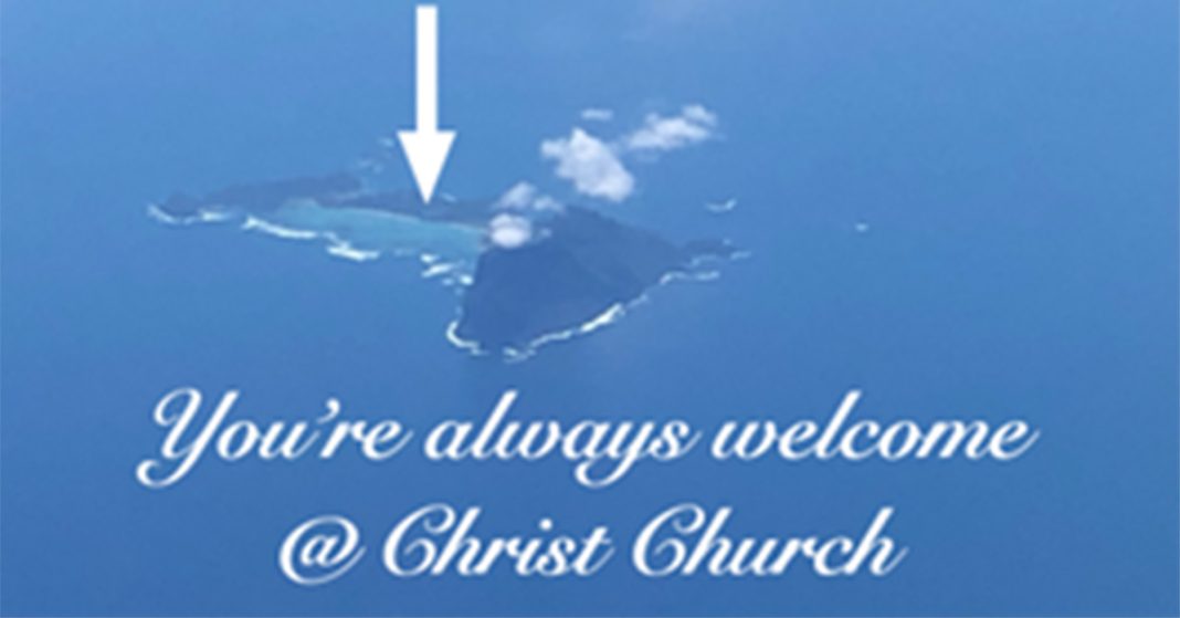 An aerial view of Lord Howe Island with arrow showing the Anglican Christ Church.