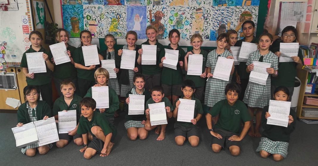 A group of Lord Howe Island Central School students showing their pen pal letters