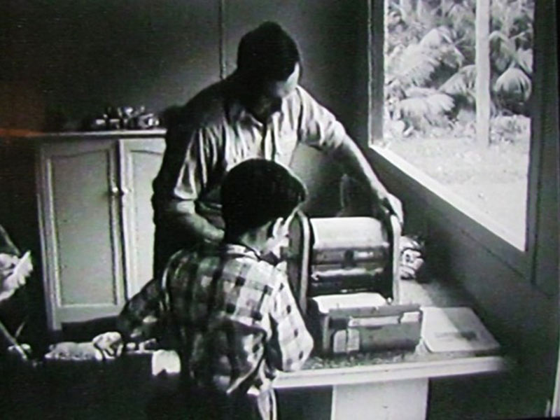 Jim Whistler with son, Philip, printing the Signal on a Gestetner duplicating machine.