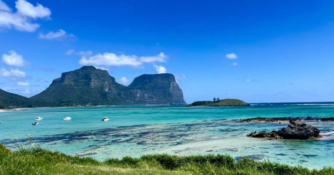 Beautiful coastal beach on Lord Howe Island with the two mountains in the background.